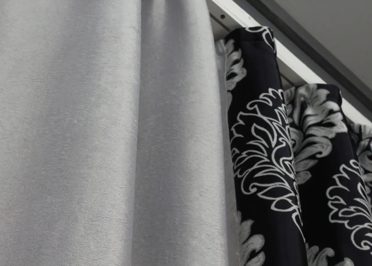 Black and light grey blackout curtains adding a dramatic contrast and elegance to contemporary living spaces.
