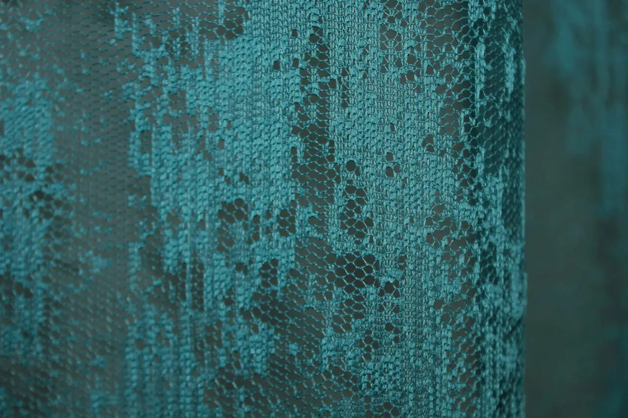 Bright teal curtain for soft natural light diffusion