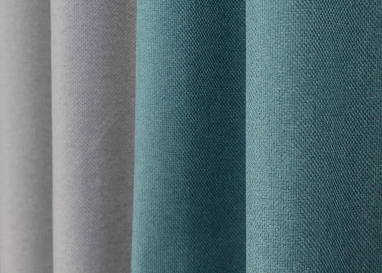 Timeless light grey and turquoise linen curtains, expertly crafted for effortless elegance, ideal for modern living rooms and office spaces.