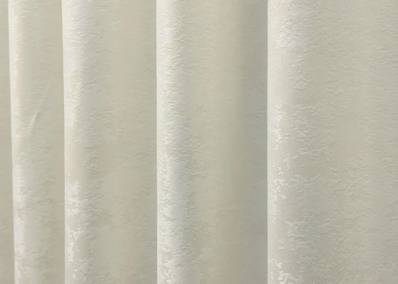 Classic-style cream jacquard curtains with matching tie-backs, ideal for achieving a refined and polished window treatment.