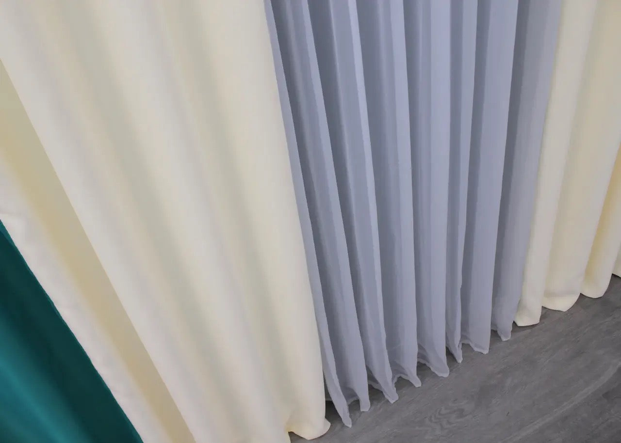 Elegant emerald and cream combined blackout curtains, providing a perfect balance of functionality and style for contemporary living spaces.