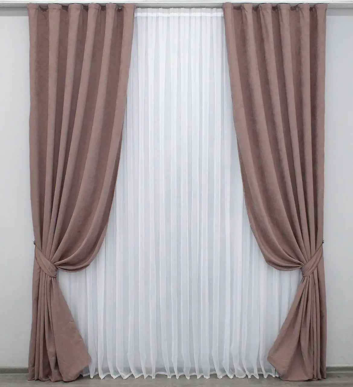 Luxury blush pink velvet curtains with a smooth texture, ideal for stylish bedrooms and living rooms.