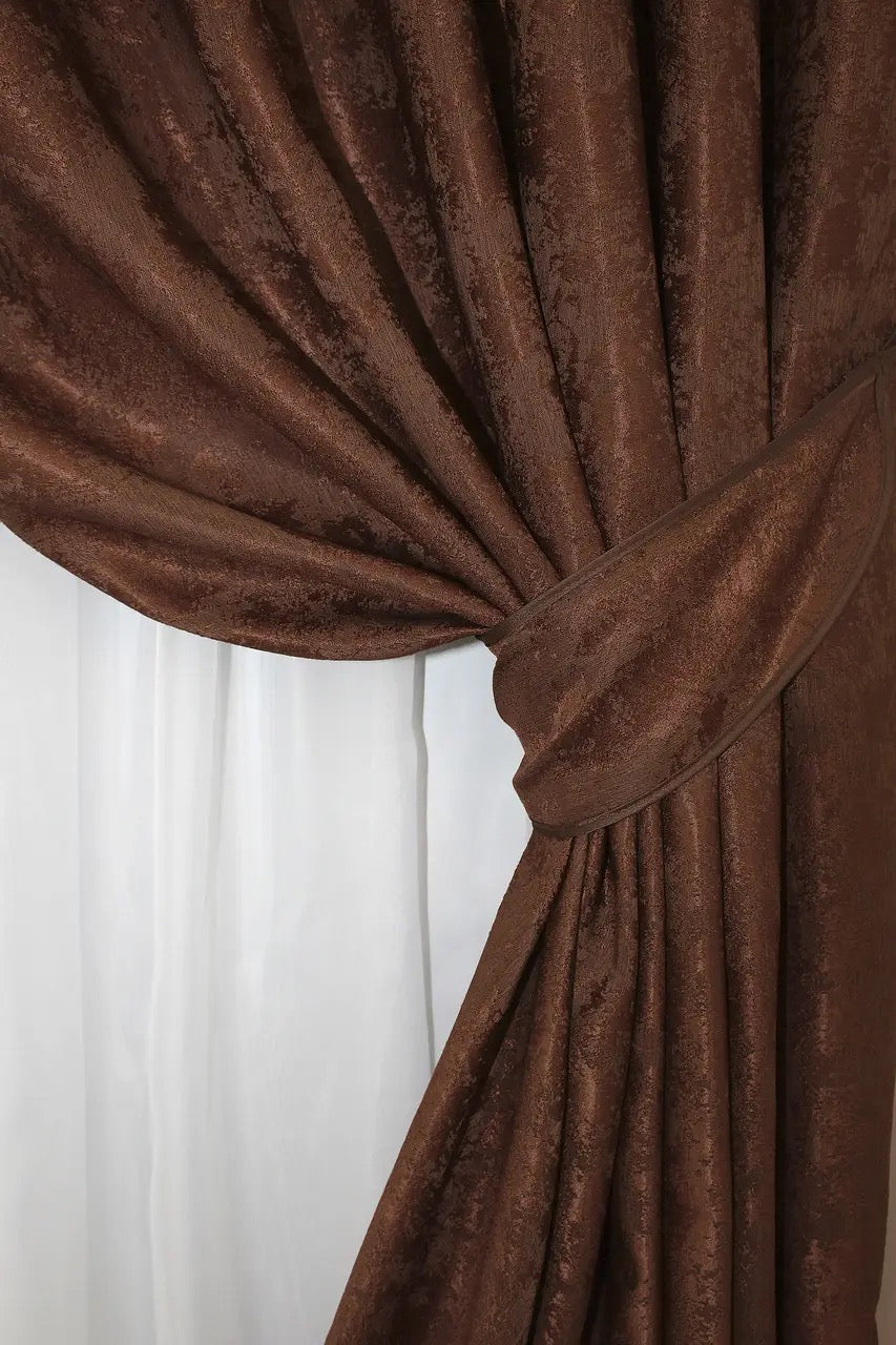 Non-blackout brown-burgundy jacquard curtains that provide privacy while letting soft natural light illuminate the room.