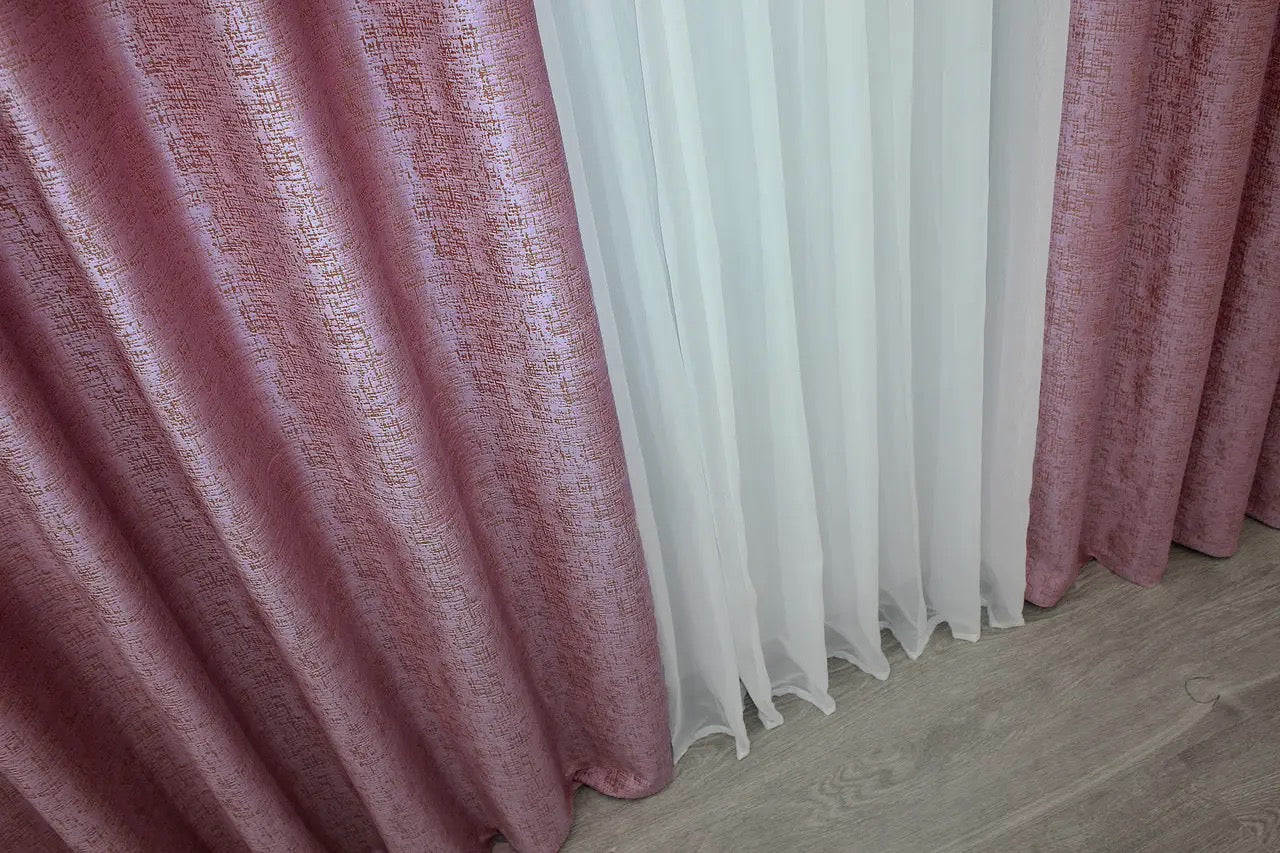 Elegant pink and gold velvet curtains, soft to the touch and offering superior light-blocking performance for a peaceful atmosphere.