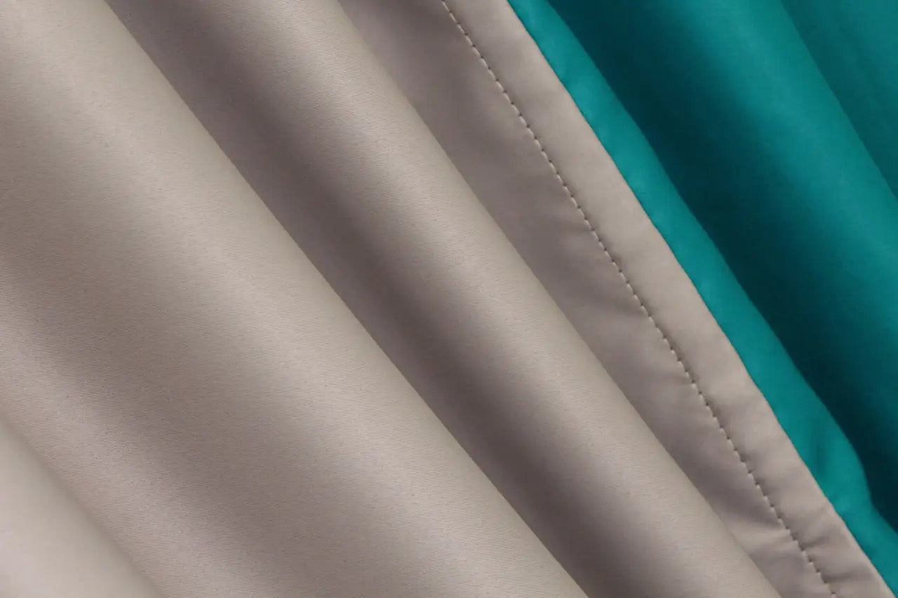 Premium dual-tone turquoise and chocolate combined blackout curtains with a smooth finish and stylish tie-backs.