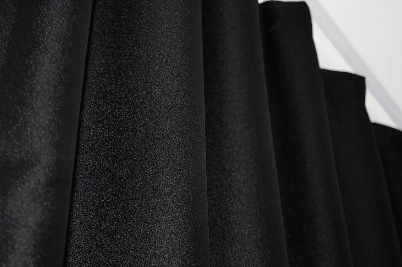 Ultra-soft black-grey linen drapes with gold pattern, adding depth and sophistication to any room.