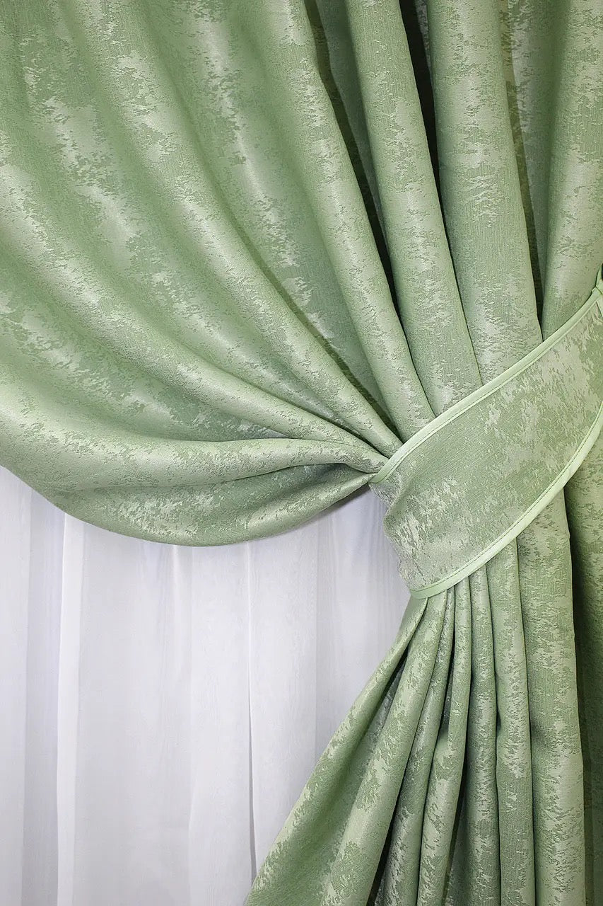 Semi-blackout mint jacquard curtains that filter natural light while enhancing the aesthetics of any space.