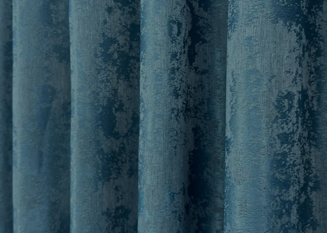 Opulent azure blue curtains with a textured jacquard design, bringing brightness and elegance to your home décor.