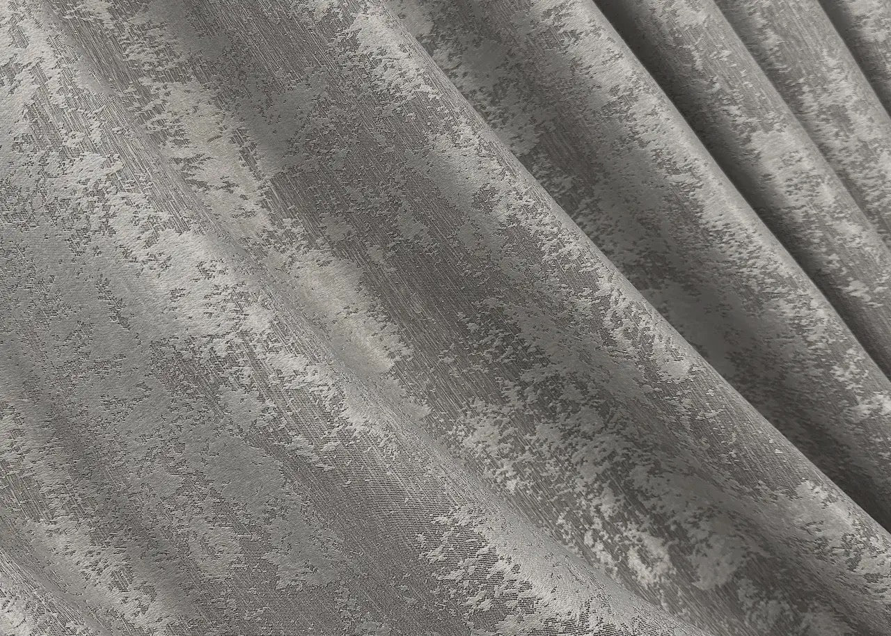 Opulent light silver curtains with an elegant jacquard weave, enhancing interiors with a touch of refinement and radiance.