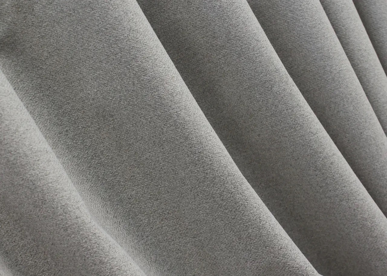 Modern blackout linen curtains in light grey, blocking out external light and enhancing home comfort and style.