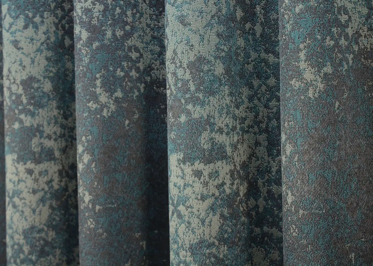 Sophisticated linen curtains in deep teal and charcoal grey, enhancing industrial and contemporary décor.