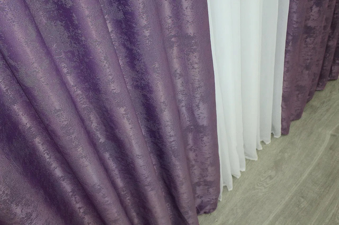 Vibrant purple curtains with a luxurious tone, blending seamlessly into contemporary and traditional interior designs.