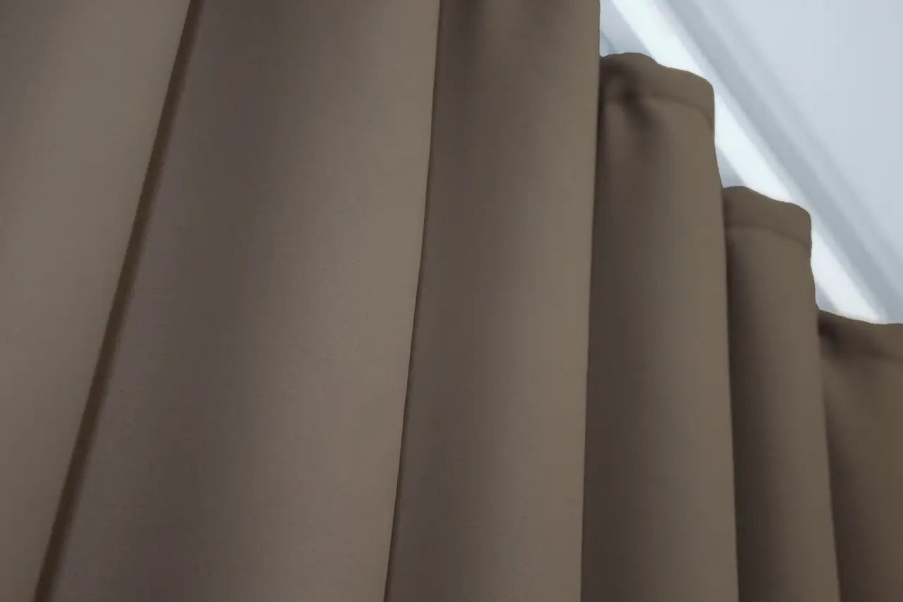 Warm neutral blackout curtains with a high-quality blackout lining.