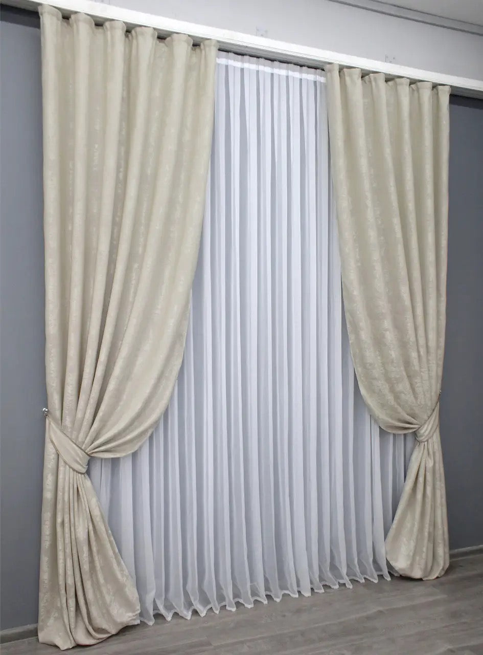 Elegant beige curtains with matching tie-backs for a polished look.
