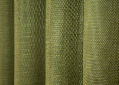 Warm matte green linen curtains with a coarse weave, providing privacy while allowing soft, diffused natural light.
