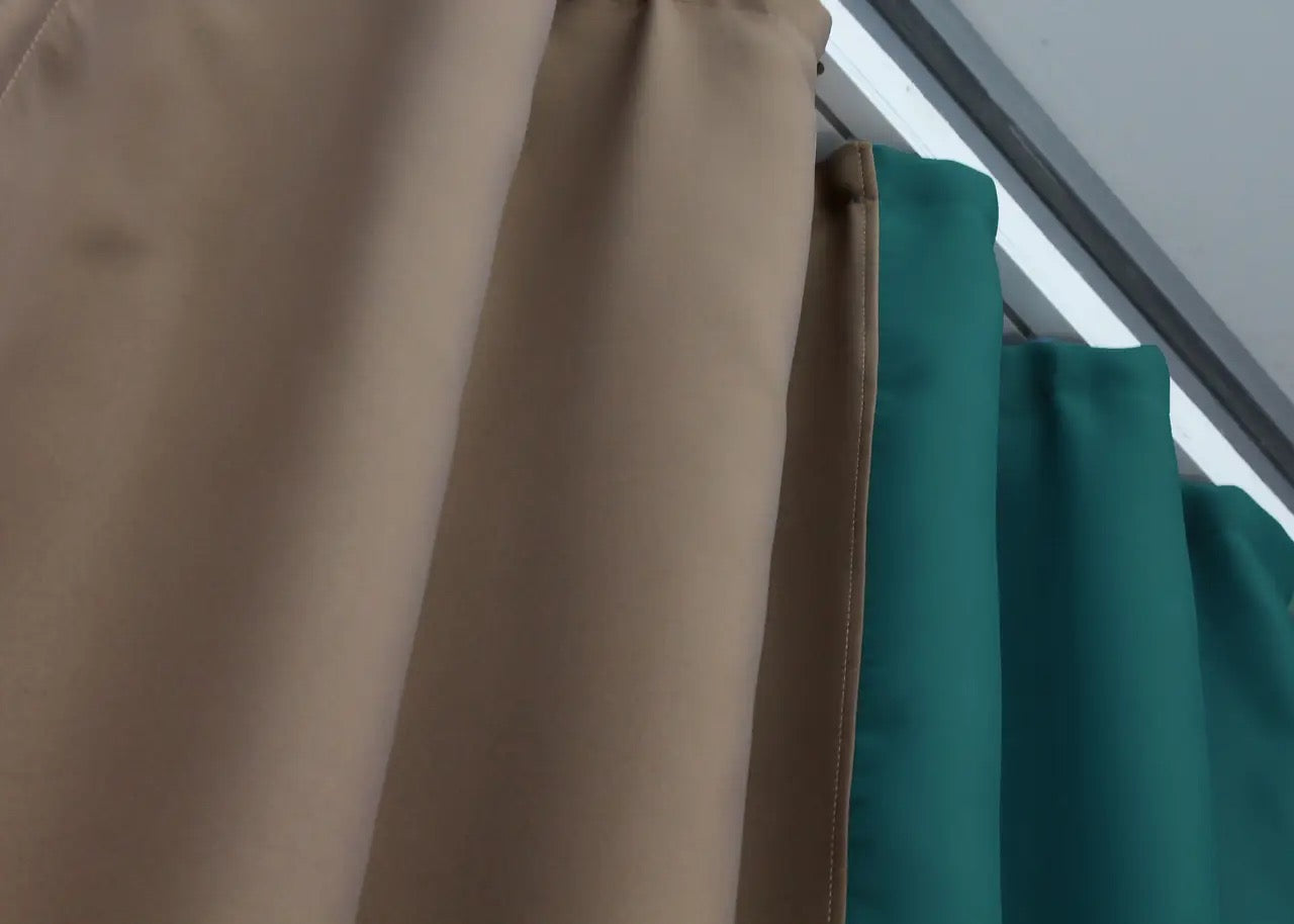 Refined emerald green (also referred to as Pine Green) and dark beige (known as Sand) blackout curtains with soft fabric, designed for privacy and a chic ambiance.
