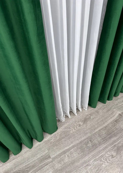 Hunter green velvet curtains with an ultra-soft plush texture, perfect for light blocking and a cozy atmosphere.
