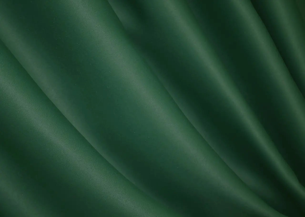 Bottle green blackout curtains designed for a cosy and sophisticated home setting.
