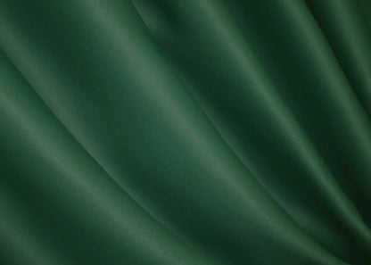 Bottle green blackout curtains designed for a cosy and sophisticated home setting.
