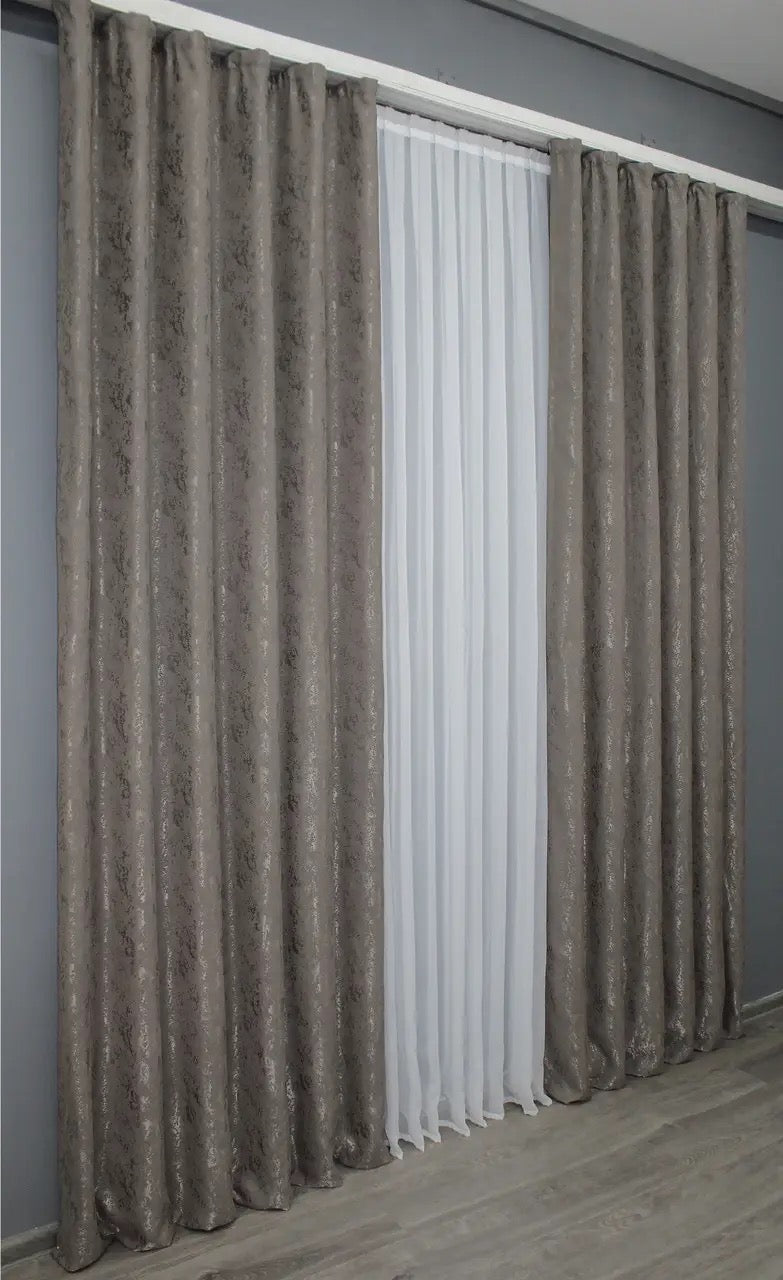 Modern brown-grey linen curtains, designed to softly filter light while maintaining a serene atmosphere.
