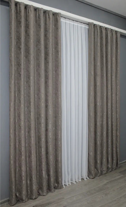Modern brown-grey linen curtains, designed to softly filter light while maintaining a serene atmosphere.
