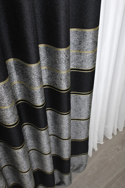 Dark charcoal grey linen curtains with subtle gold detailing, ideal for chic and elegant spaces.
