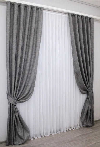 Charcoal grey linen curtains with a textured fabric, perfect for creating a contemporary and inviting home atmosphere.
