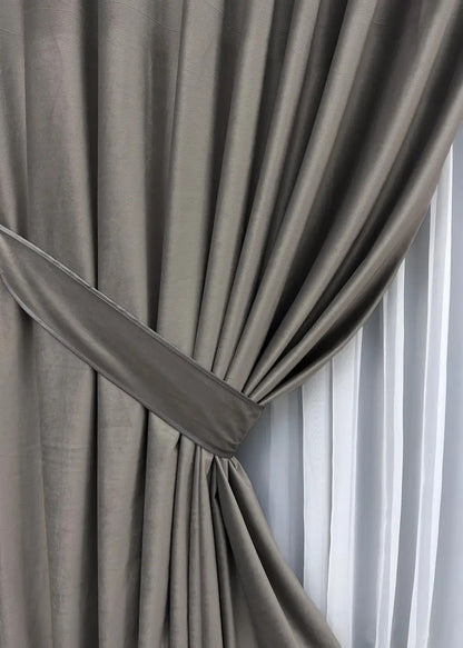 Charcoal grey luxury velvet curtains with premium blackout properties, perfect for contemporary home interiors and peaceful atmospheres.
