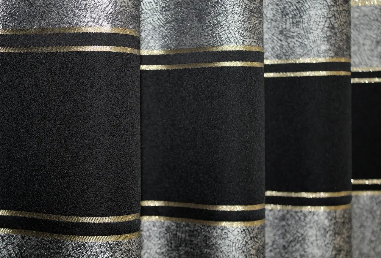 Classic black-grey curtains with a refined gold trim, creating a sleek and stylish atmosphere.
