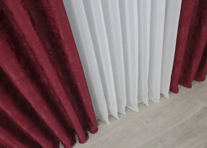 Classic burgundy curtains with a sophisticated tone, seamlessly blending into luxurious interior designs.
