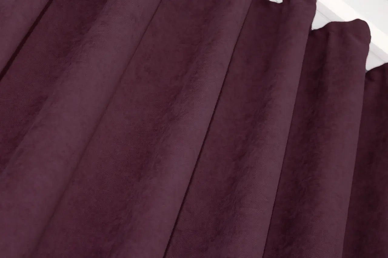 Rich burgundy window drapes, combining light filtering with a timeless aesthetic.
