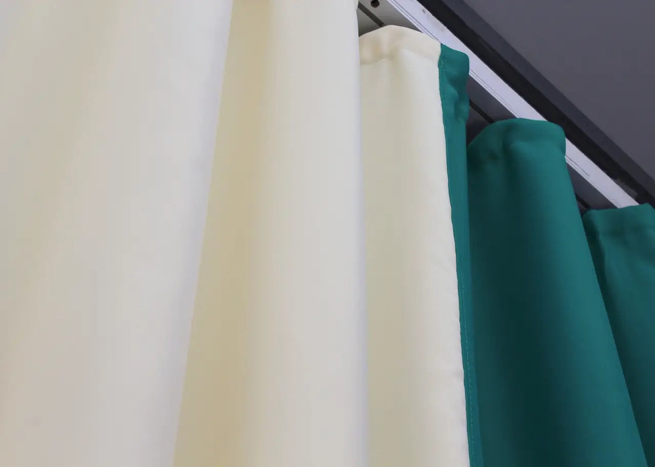 Stylish two-tone emerald green and cream blackout curtains that offer premium light-blocking performance and a refined design.
