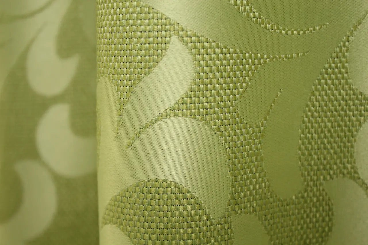 High-quality olive green Venzel drapes with a woven ornamental texture, perfect for an elegant setting.
