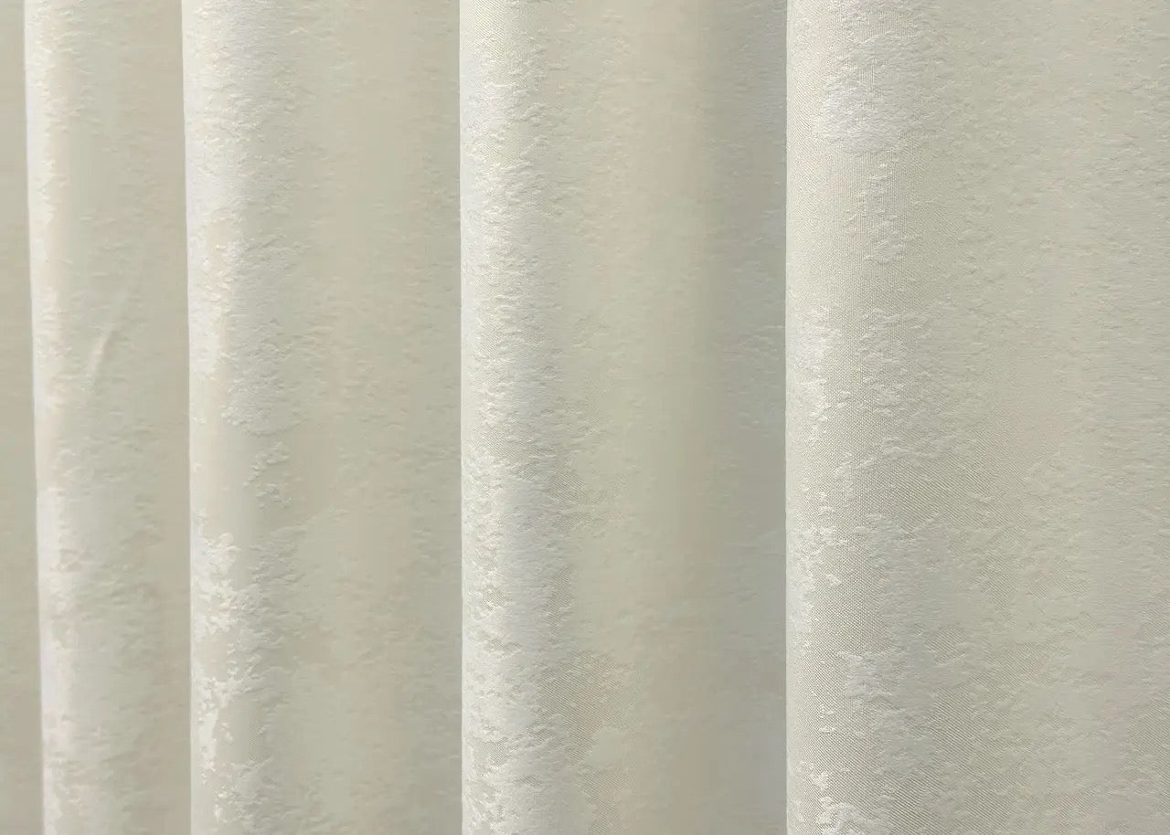 Classic-style cream jacquard curtains with matching tie-backs, ideal for achieving a refined and polished window treatment.
