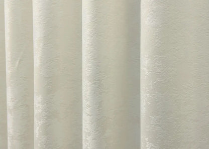 Classic-style cream jacquard curtains with matching tie-backs, ideal for achieving a refined and polished window treatment.
