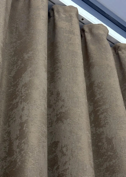 Elegant cocoa brown curtains styled in a bedroom setting, creating a warm and sophisticated ambiance.
