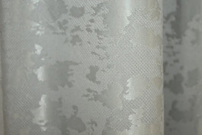 Classic and neutral light grey linen curtains, offering privacy while allowing soft, diffused natural light.
