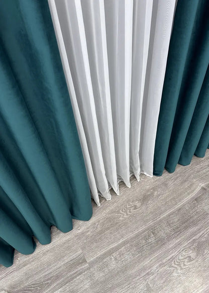 Dark aqua velvet drapes, crafted for a refined and elegant look in bedrooms and living rooms.
