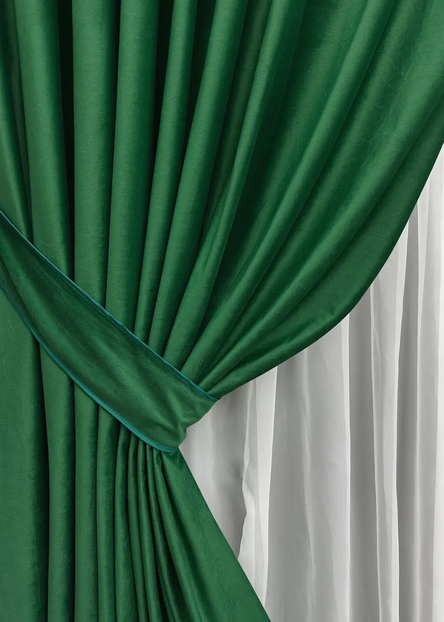 Bottle green velvet room-darkening curtains, crafted for high-end interior design and improved privacy.
