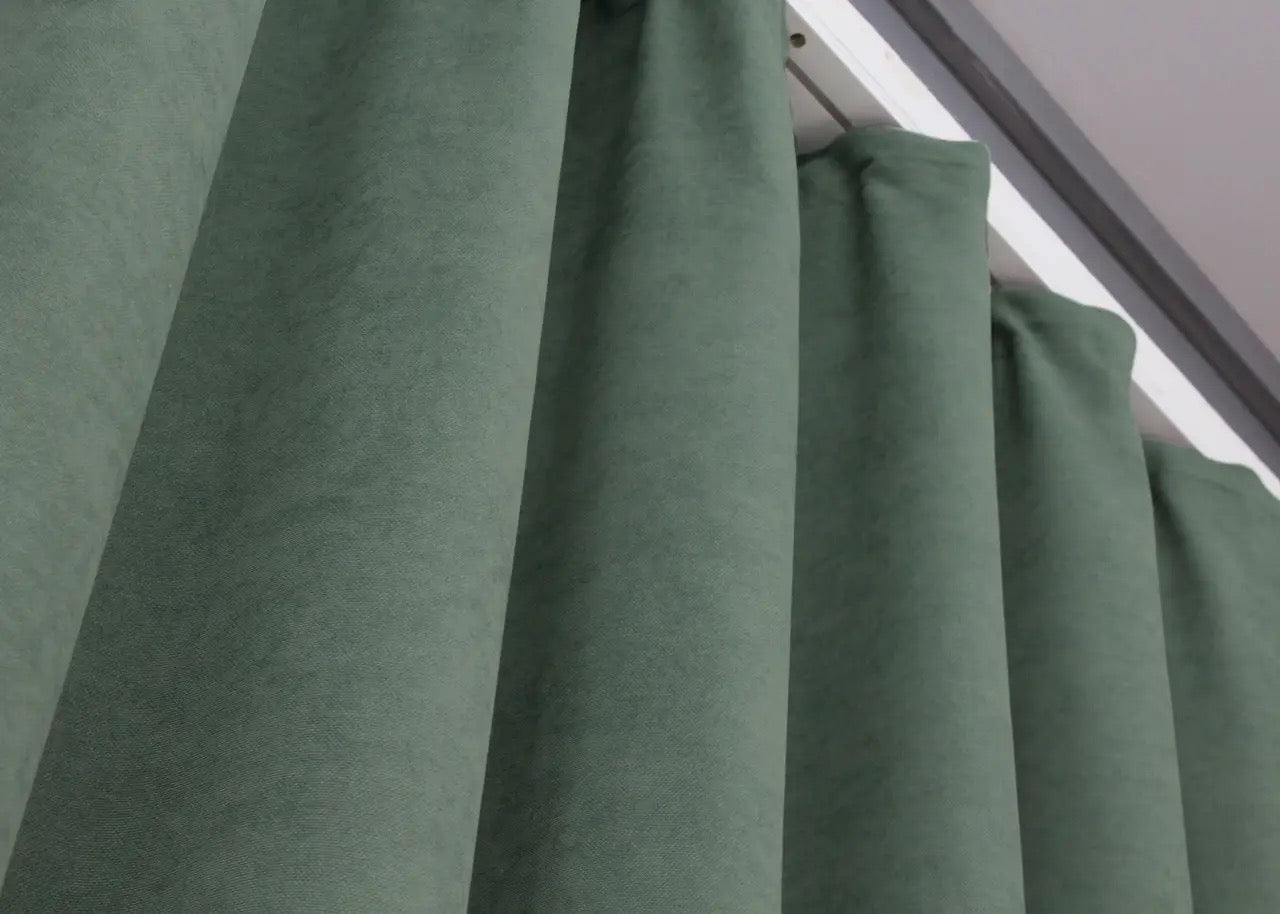 Premium soft green velvet curtains, offering a sophisticated yet cosy atmosphere.
