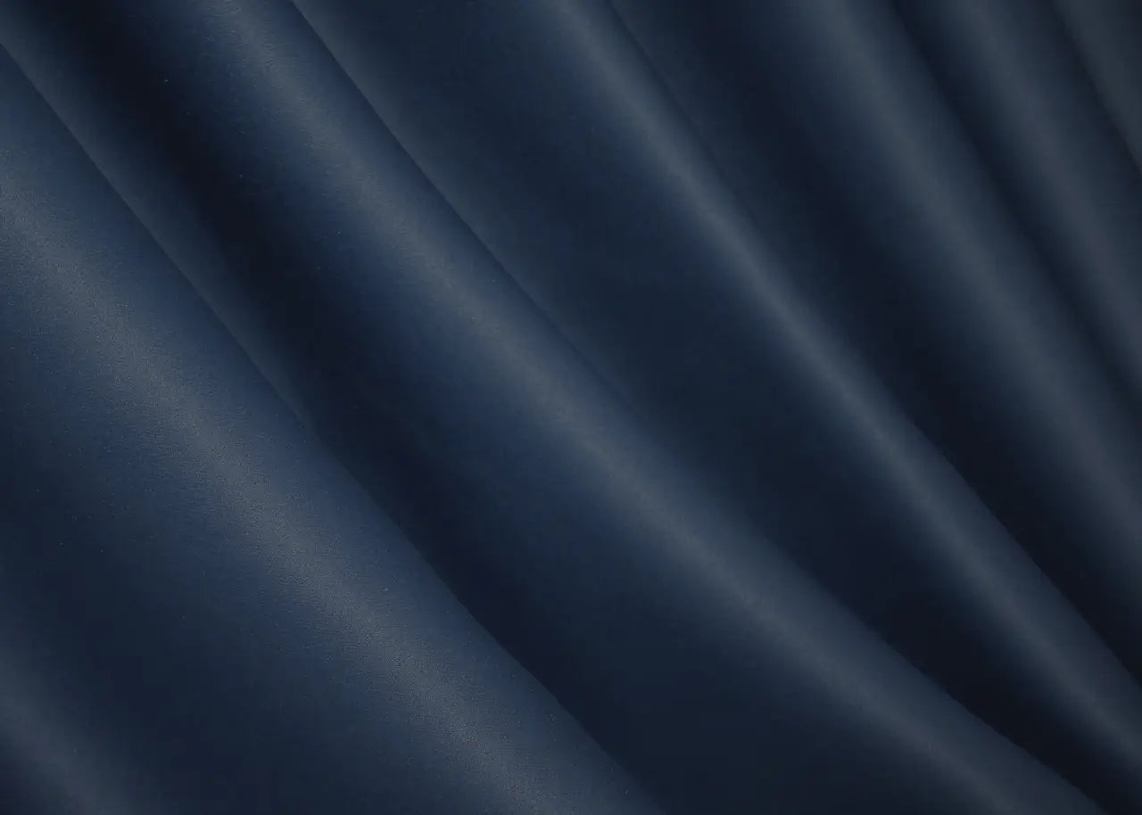 Dark blue blackout curtains providing an elegant, functional window covering.
