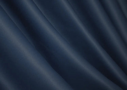 Dark blue blackout curtains providing an elegant, functional window covering.
