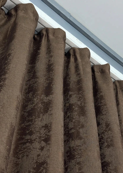 Deep brown curtains with a sophisticated tone, seamlessly blending into elegant and modern interior designs.
