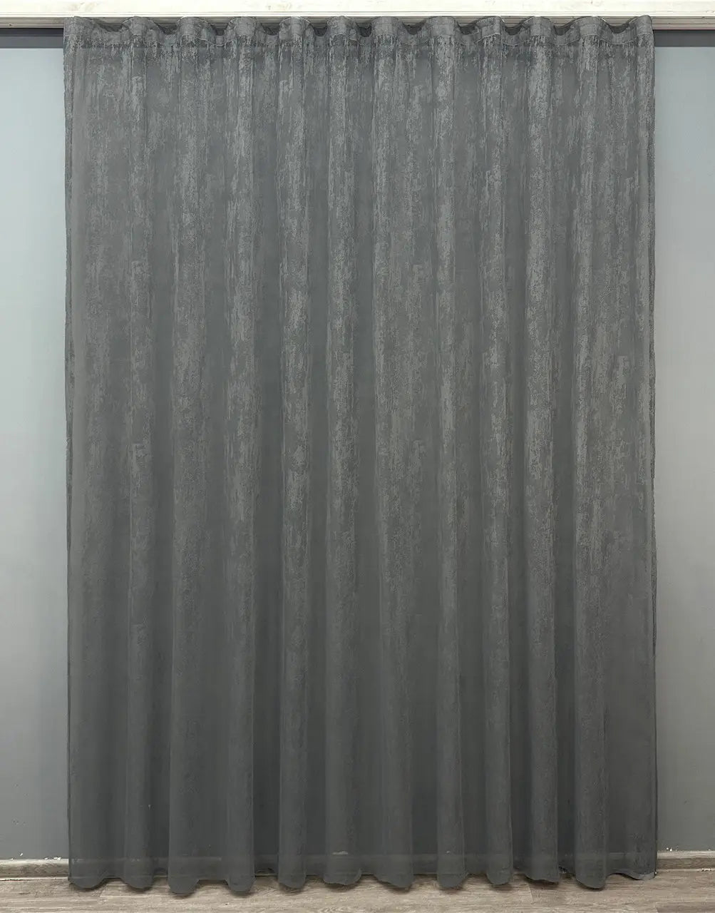 Deep grey curtain for soft light filtering in dark-themed interiors