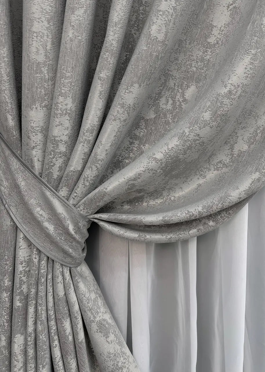 High-quality brushed silver curtains made from premium jacquard fabric, blending effortlessly into minimalist and glamorous interiors.
