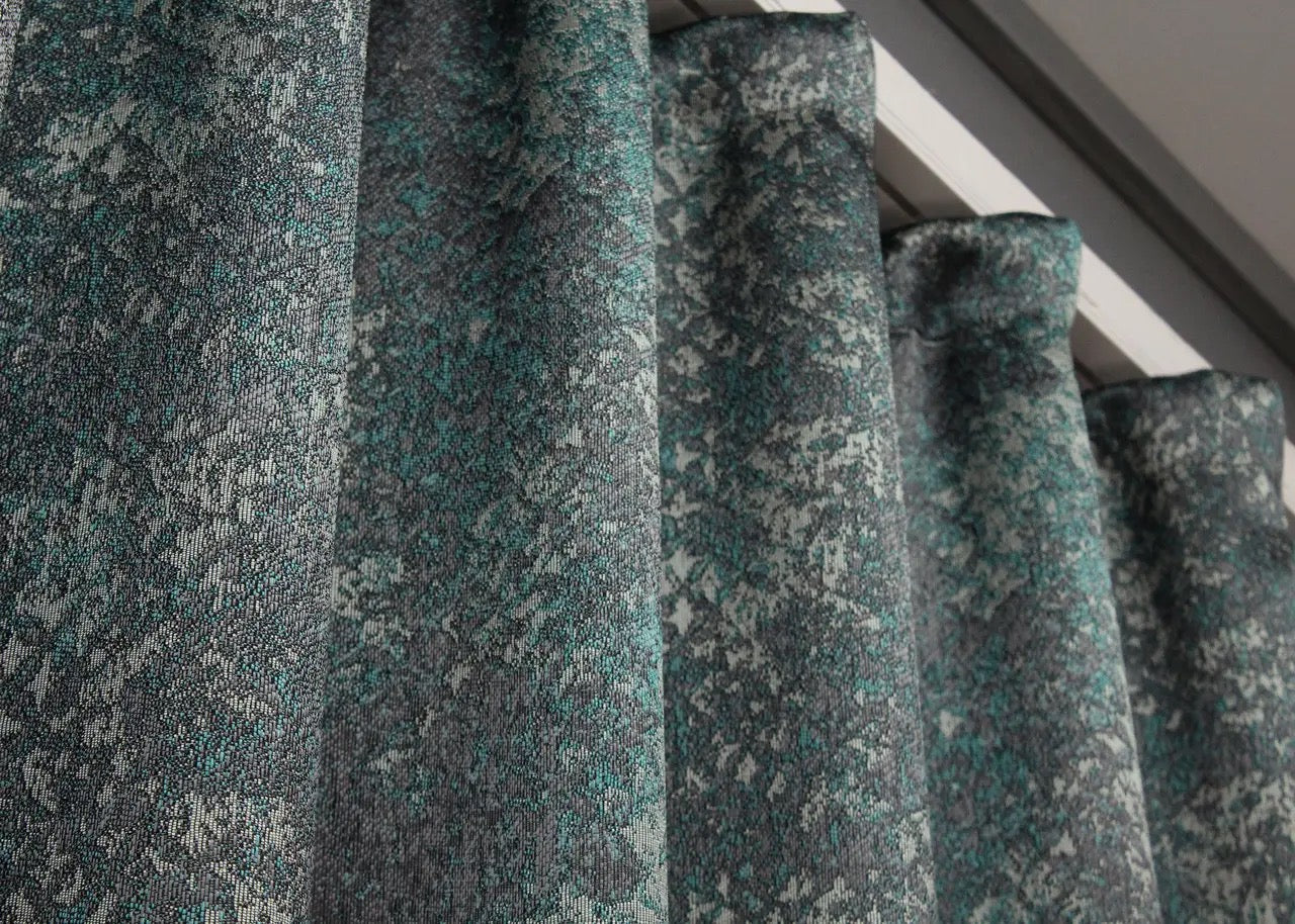 Minimalist marble-pattern linen curtains in deep teal and charcoal grey, perfect for stylish homes.
