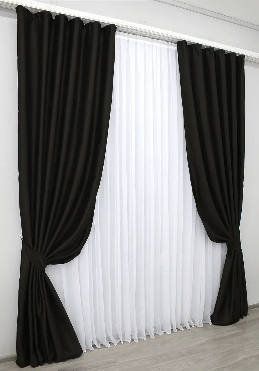 Deep charcoal blackout curtains designed for energy efficiency and privacy.
