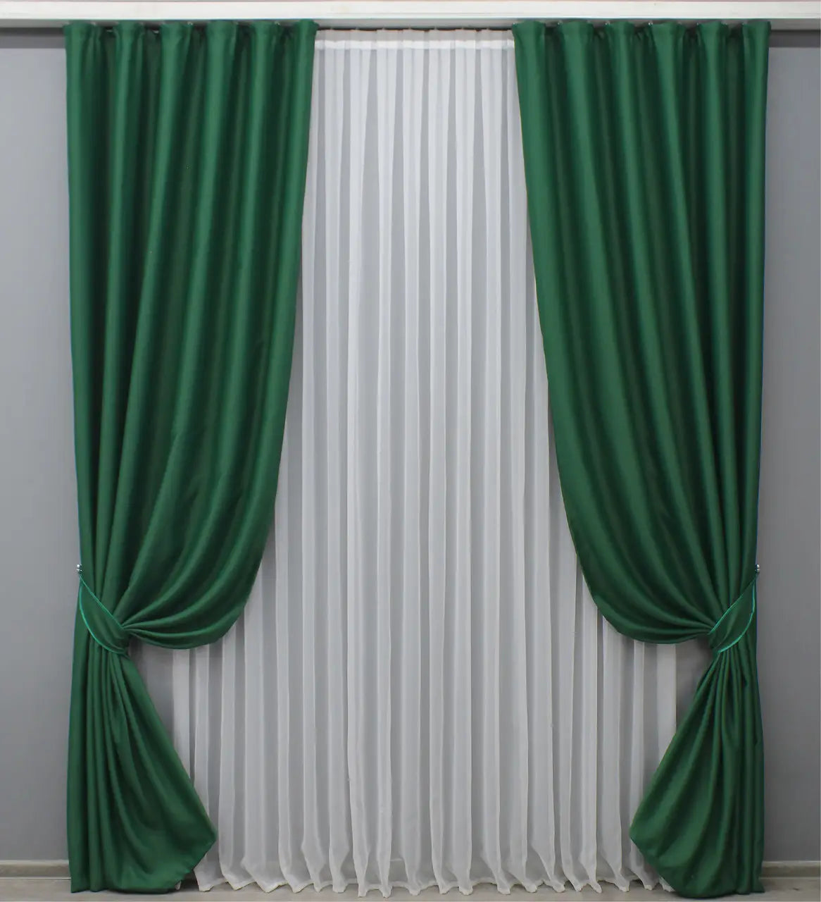 Deep emerald blackout curtains designed for privacy and insulation.

