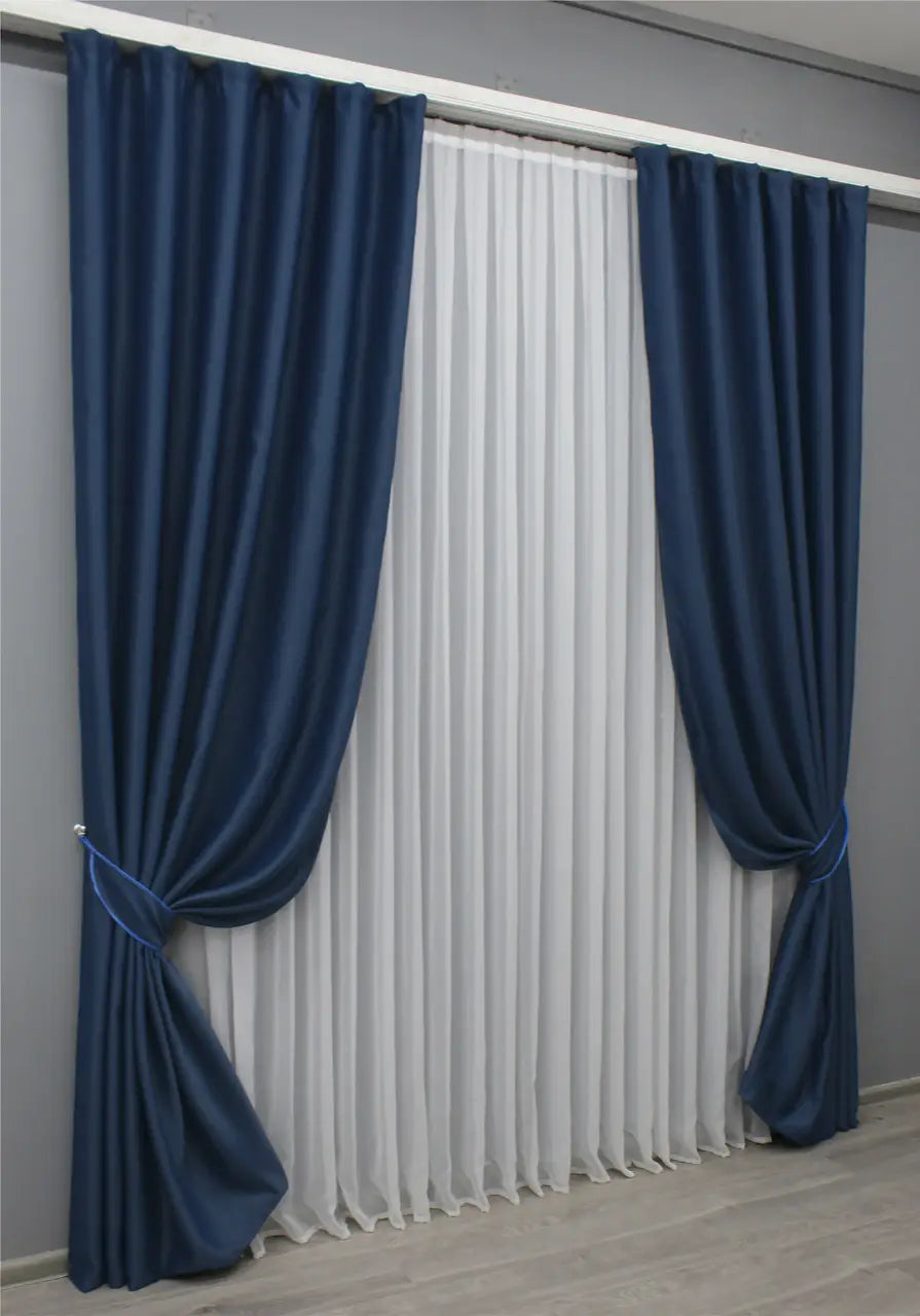 Deep sapphire blackout curtains with a soft, smooth texture and elegant drape.
