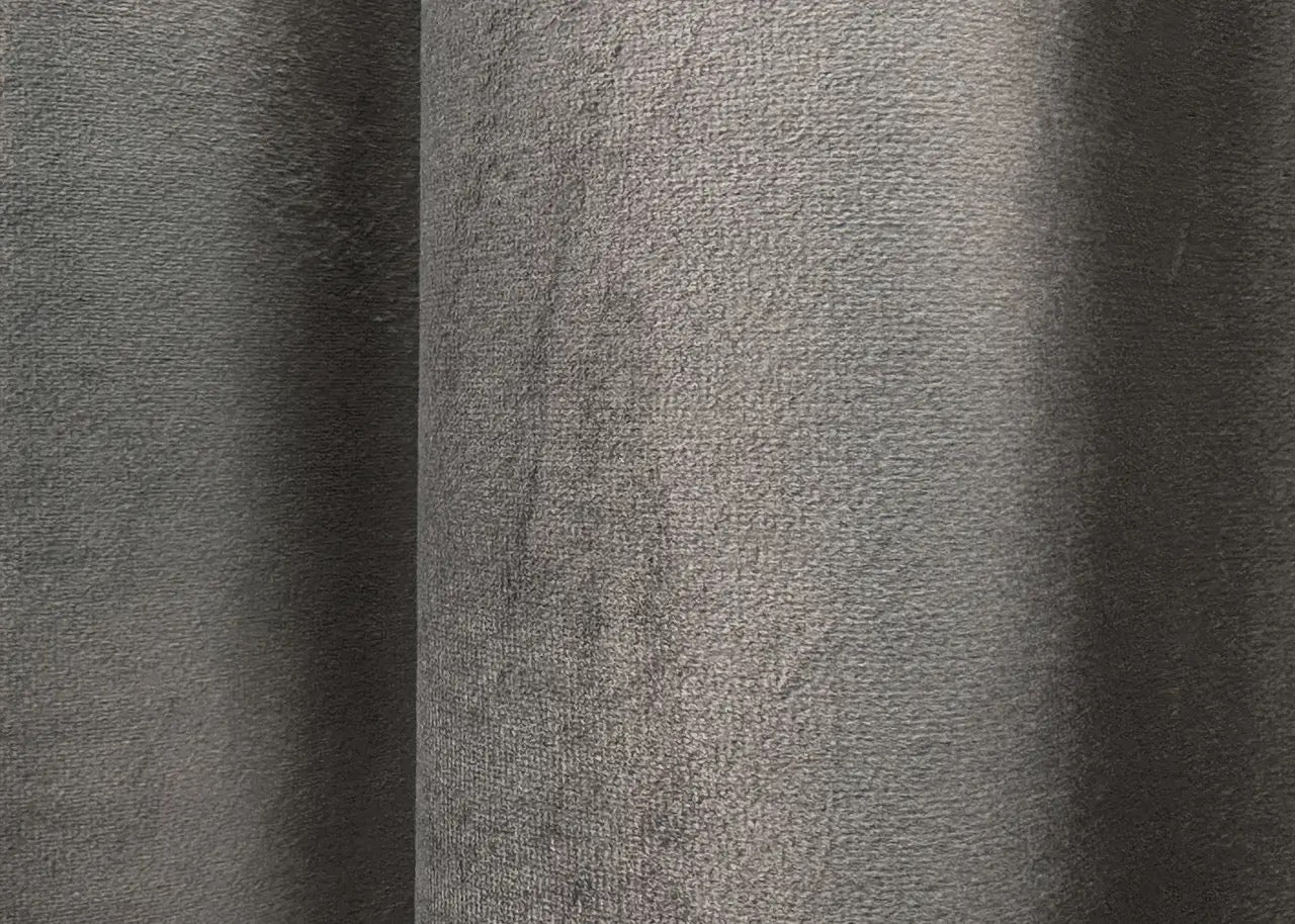 Earthy grey luxury velvet drapes with a thick, elegant texture, reducing light and noise for an ultimate cozy home ambiance.
